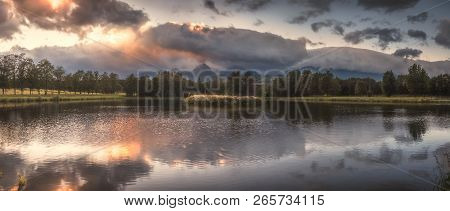 Strba Pond Lit By Golden Light At Sunset With High Tatras Mountains In Background, Slovakia.