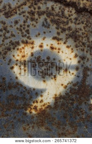 White Number Nine Painted On Rusty Blue Metal