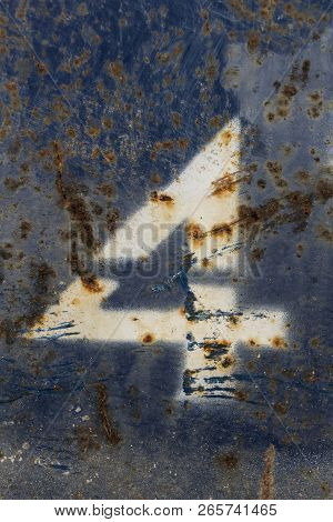 White Number Four Painted On Rusty Blue Metal