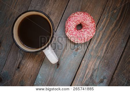 Fresh Donut With Cup Of Coffee On The Wooden Table