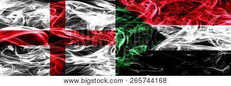 England Vs Sudan, Sudanese Smoke Flags Placed Side By Side. Thick Colored Silky Smoke Flags Of Engli
