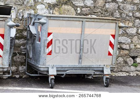 Dump Garbage Bin On Street  Near Concret Wall For Waste In Europe