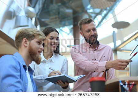 Group Of Young Modern People In Smart Casual Wear Having A Brainstorm Meeting While Standing In The 