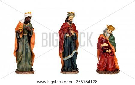 The three wise men and baby Jesus. Ceramic figures isolated on white background