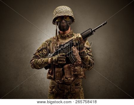 Soldier agent in a dark room with arms on his hand and gas mask
