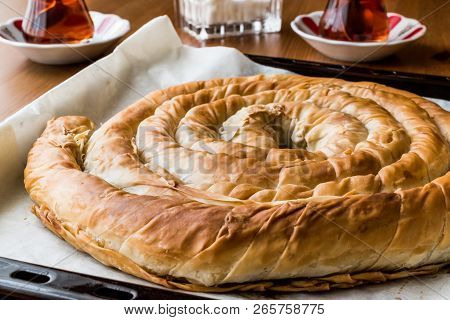 Turkish Tepsi Boregi / Round Borek In Tray With Tea.