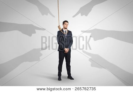 Young businessman trying to suicide with pointing hands concept