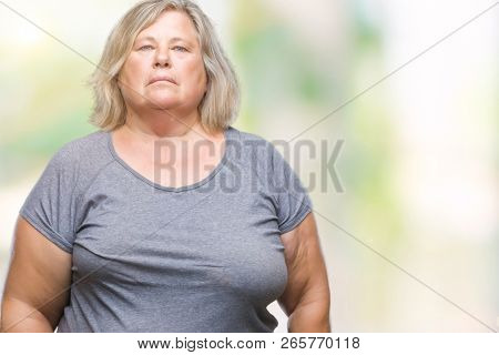Senior plus size caucasian woman over isolated background with serious expression on face. Simple and natural looking at the camera.