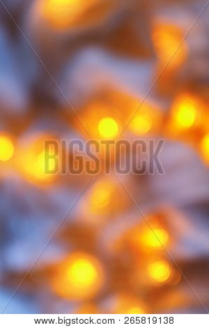 Background From Blurry Light Lights Of Fir-tree Garland On Dark. Copy Space.