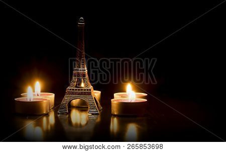 Eiffel Tower On The Background Of Colorful Lights Garland, Bokeh. Eiffel Tower Small Model And Candl