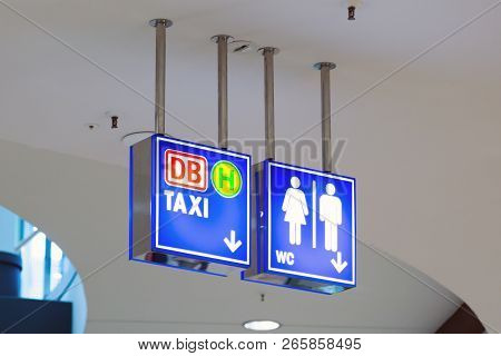 Blue Illumintaed Neon Signs In A Public Shopping Mall