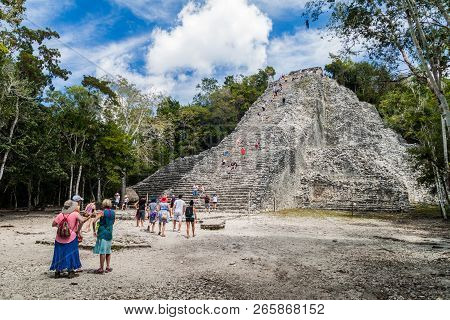 Coba, Mexico - March 1, 2016: Tourist Visit The Pyramid Nohoch Mul At The Ruins Of The Mayan City Co