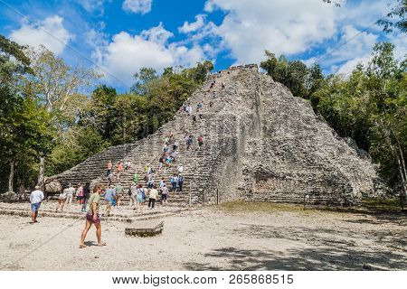 Coba, Mexico - March 1, 2016: Tourist Climb The Pyramid Nohoch Mul At The Ruins Of The Mayan City Co