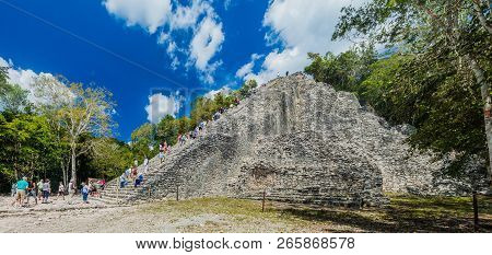 Coba, Mexico - March 1, 2016: Tourist Climb The Pyramid Nohoch Mul At The Ruins Of The Mayan City Co