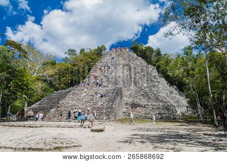 Coba, Mexico - March 1, 2016: Tourist Climb The Pyramid Nohoch Mul At The Ruins Of The Mayan City Co