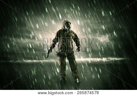 Terrorist in a stormy space with gas mask on his hand and weapons on his arm