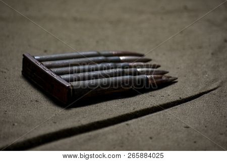 Holder With Cartridges 7, 92 X 57 - Rustic Ammos And Poncho Lies On The Wooden Background