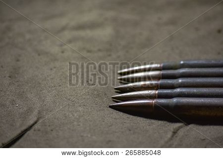 Holder With Cartridges 7, 92 X 57 - Rustic Ammos And Poncho Lies On The Wooden Background