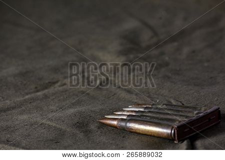Holder With Cartridges 7, 92 X 57 - Rustic Ammos And Poncho Lies On The Wooden Background