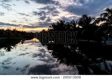 Sunset Over Dangriga River In Dangriga Town, Belize
