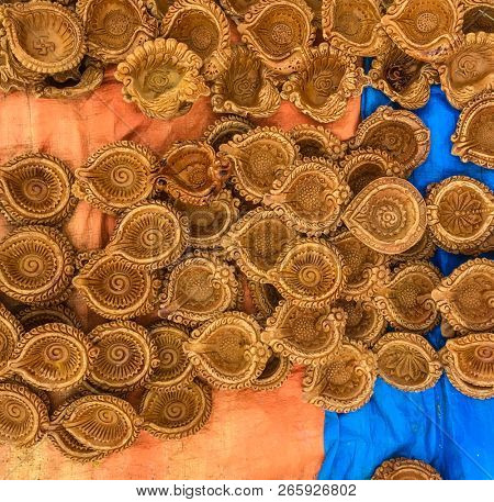 Lot of Indian traditional clay oil lamps laid on the floor in the street shop. 