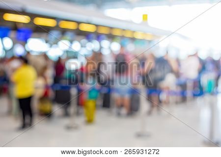 Blurred Photo Of People Getting In Line At The Airline Check In Ticket Booths, With Light Lens Flare