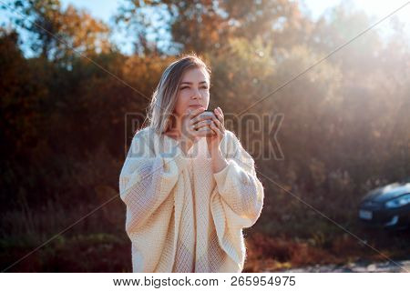 Beautiful Admiring Woman Drinking Hot Tea From Thermos Cup With Backligth Sun.