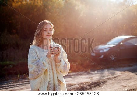 Beautiful Admiring Woman Drinking Hot Tea From Thermos Cup With Backligth Sun.