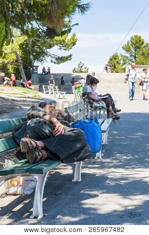 Avignon, France - July 24, 2011: Homeless Man Is Sleeping Oudoors In Old Town With Knife Under The B