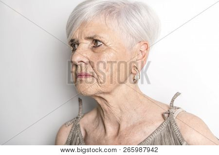 A Hard Portrait Of Senior Woman On Studio