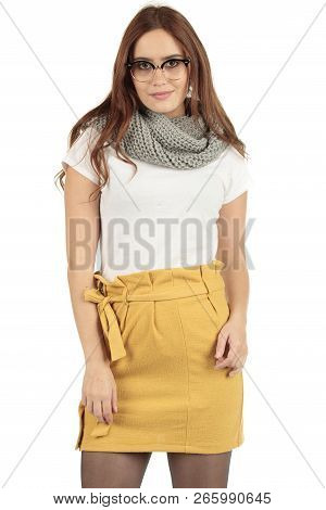 Cute Smiling Preppy, Fashion Geek Girl In A White T-shirt And Yellow Skirt