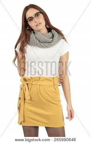 Cute Smiling Preppy, Fashion Geek Girl In A White T-shirt And Yellow Skirt