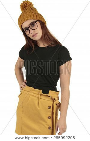 Cute Smiling Preppy, Fashion Geek Girl In A Black T-shirt And Yellow Skirt