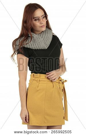 Cute Smiling Preppy, Fashion Geek Girl In A Black T-shirt And Yellow Skirt