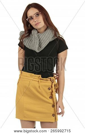 Cute Smiling Preppy, Fashion Geek Girl In A Black T-shirt And Yellow Skirt