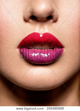 Close up view of beautiful woman lips with  gloss lipstick.  fashion makeup concept. Beauty studio shot. Gloss.