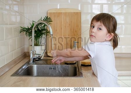 Adorable Toddler Girl Washing Her Hands Under Kitchen Sink. Little Girl Having Fun With Water. Hygie
