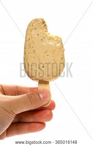 Hand Holding A  Seaweed Flavor Popsicle With A Bite On White Background