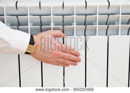 Checking The Temperature Of The Heating Radiator.feel All The Radiators In Your Home.a Man Will Chec