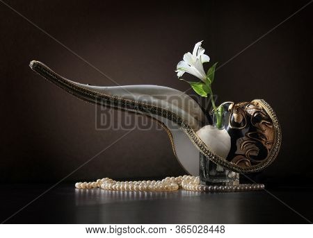 Retro Style Still Life With Beaked Venetian Carnival Plague Doctor Mask, Alstroemeria Flower In The 