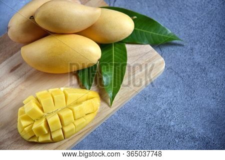 Tropical Fruits. Fresh And Beautiful Mango Fruit Set In A Wooden With Sliced Diced Mango Chunks On A