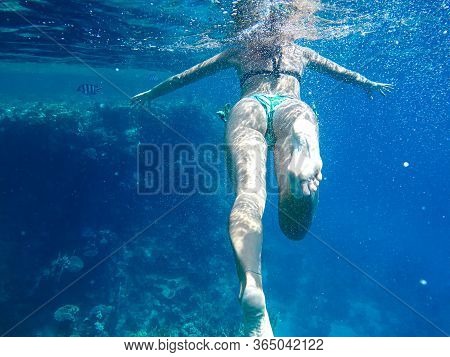 Girl Snorkler Swims Underwater In The Sea.
