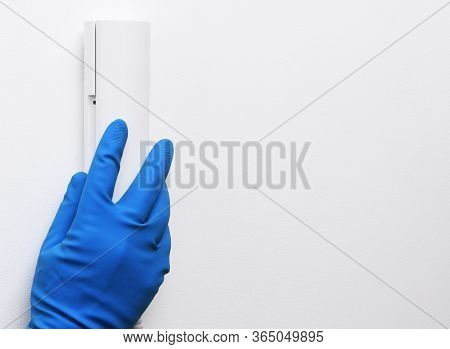 Disinfection In Public Places, The Fight Against The Virus, Coronavirus. The Working Hand Hangs Up T