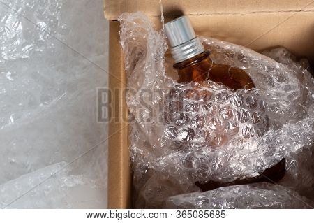 Bottle Of Eau De Toilette In A Cardboard Box And Soft Bubble Wrap For Safe Shipment