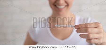 Happy Woman Shows A Positive Ovulation Test. The Concept Of Female Fertility And High Luteinizing Ho