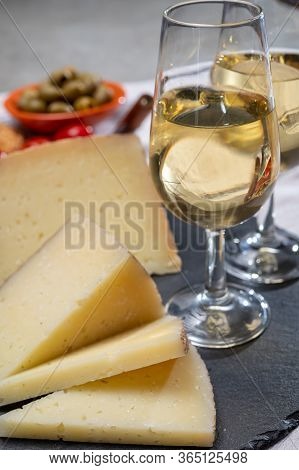 Spanish Tapas, Manchego Cheese Made, Green Olives Served With Glasses Of Dry Fino Sherry Wine Close 