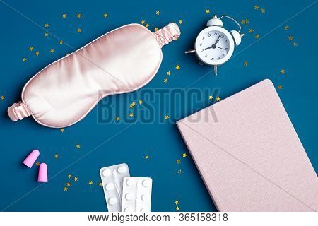 Flat Lay Composition With Sleep Eye Mask, Alarm Clock, Dream Book, Sleeping Pills For Insomnia, Pink