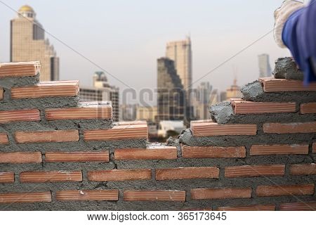 Wall Laying Bricks In Construction  On The Background Of The Building, Basic Concepts Of Constructio