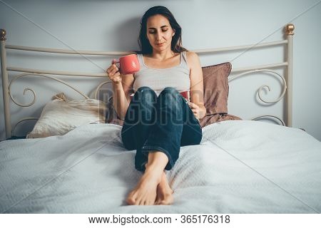 Woman Reading Book At Home On Bed. Woman Relaxing On Bed At Home. Hipster Lifestyle. Beautiful Woman