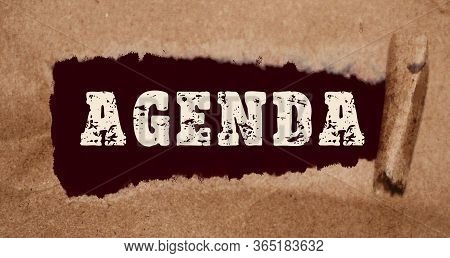 The Word Agenda Appearing Behind Torn Brown Paper. Conceptual Image